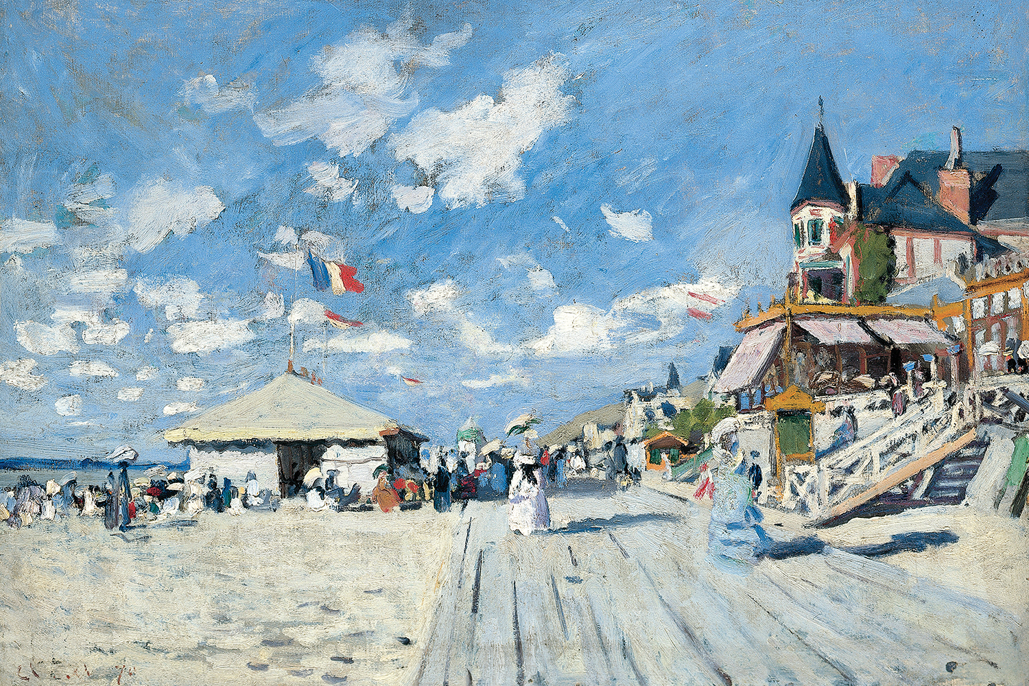 boardwalk along the beach showing tents, houses, and passerbys