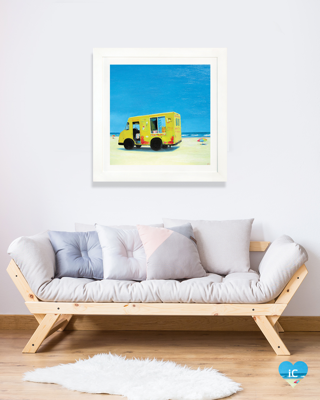 yellow ice cream truck parked on beach with water in view