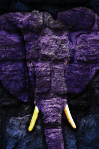 a purple elephant made out of rocks