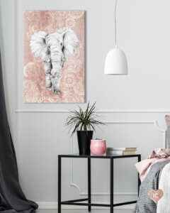 a large gray elephant walking towards you on a pink paisley background