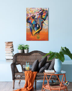 a colorful elephant with tusks walking in an orange field and colorful branches in the background