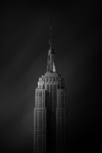 a black and white photograph showing the top of the empire state building in new york