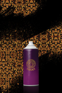 Graphic of a purple spray can with Versace logo on front on a black background sprayed with gold Versace pattern