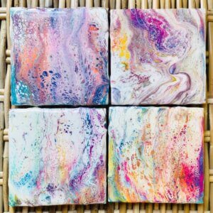 Four square coasters with bright multi-colored resin design