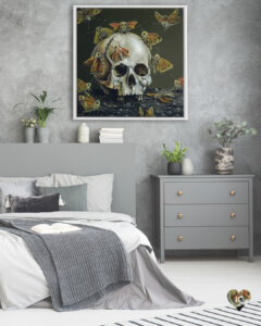 Skull surrounded by butterflies in a white frame on a gray wall in a bedroom with gray decor