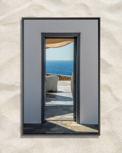 Photo of a view of balcony overlooking ocean in Mykonos through a doorway