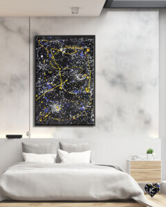 Abstract image with splattered blue yellow and white dots and lines on a black background hanging on a marble wall in minimalist bedroom