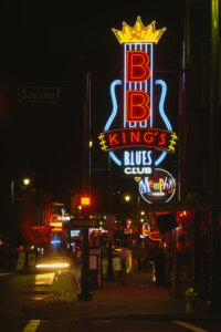 Photo of street in Memphis at night lit up by a neon sign of BB King&#039;s Blues Club