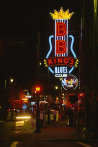 Photo of street in Memphis at night lit up by a neon sign of BB King's Blues Club