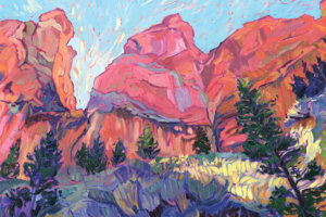“Afternoon Glory” by Jessica Johnson shows red mountains under a blue sky with pines and sagebrush glowing in the sun.