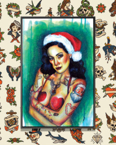 Dark haired female wearing a Santa hat and a red heart shaped bra with Christmas tattoos on her arms