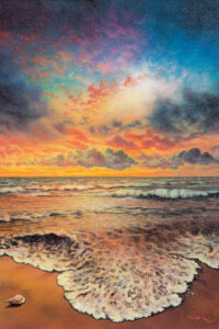 Landscape of a multicolored dusky sky over a sea shore with waves flowing in and a sea shell on the sand