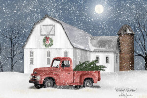 Winter scene with snow falling over a white barn with a wreath hanging on the front and a red truck with Christmas trees in the back next to it