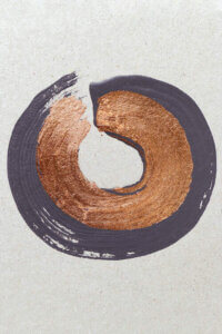 A smooth, circular brush stroke in layers of deep purple-gray and metallic copper on a linen textured white background