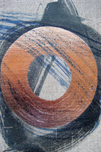 An abstract formation of a disc-like paint stroke in metallic copper surrounded by black and indigo paint strokes across and underneath it on a linen textured gray background
