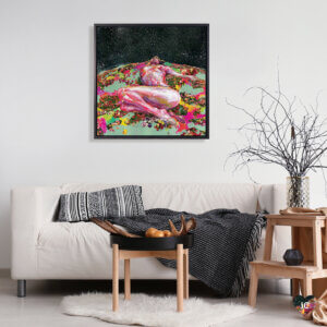 “Wild Flower” by Black Ink Art shows a pink, nude person laying on an earth-resembling floral field while staring at a starry sky.