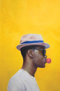 “Rocksteady” by Alexander Grahovsky shows the profile of a man wearing a fedora and sunglasses while blowing pink bubblegum against a yellow background.