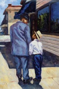 A black man wearing a blue suit and hat holding a young black boy's hands outside on a street