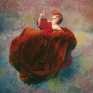 Bloom by Lola Mitchell showcases a woman with red hair wearing a red dress floating underwater