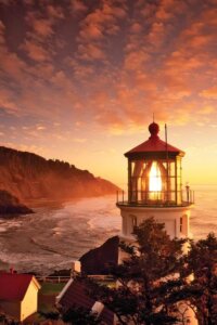 Lighthouse over beach at sunset by iCanvas artist Dennis Frates