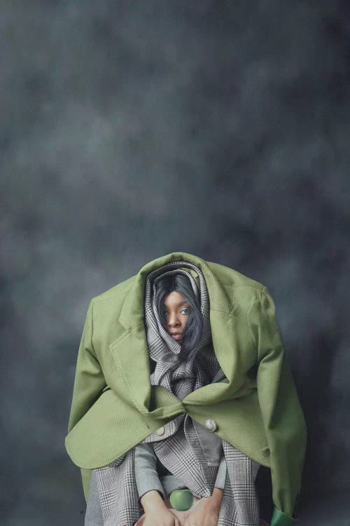 Portrait of a girl wearing blazers over head by Deandra Lee