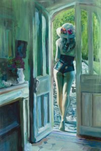 Woman in a swimsuit and hat in a doorway