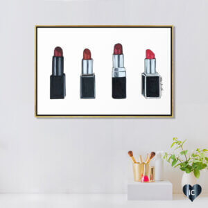 Wall art of four red lipsticks above a makeup station by iCanvas artist Elza Fouche