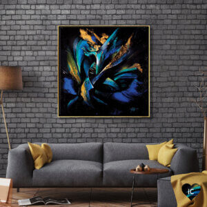 Blue and gold framed abstract art by iCanvas artist Michael Goldzweig against a brick wall above a couch
