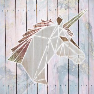 Wall art of an origami unicorn against a pastel wood panel background by Front Porch Pickins