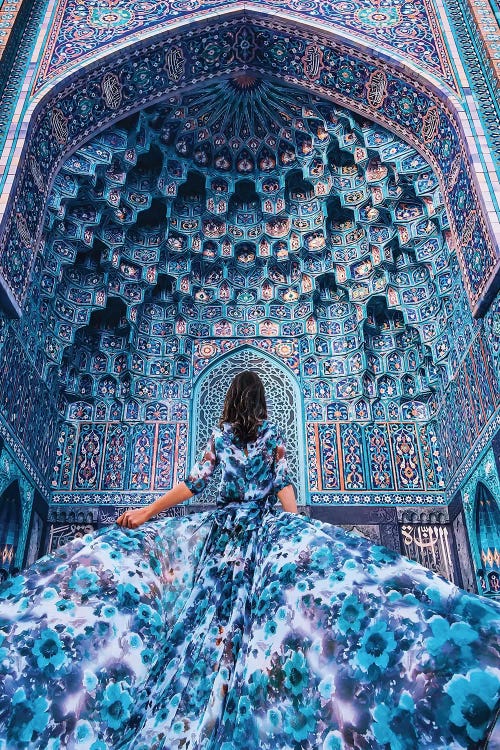 Photograph of woman in blue dress looking up at blue cathedral by female artist Hobopeeba