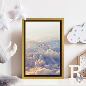 Framed wall art of a Ferris wheel above the clouds by iCanvas artist en.ps