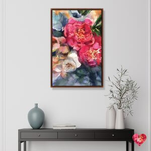 Framed floral pink and blue wall art by Gosia Gregorczyk above black table