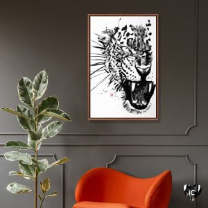 Wall art of a black and white tiger drawn by iCanvas artist Pechane above a red chair and plant