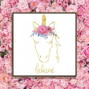Framed wall art of a unicorn outlines in gold wearing pink flower crown above word believe by Noonday Design