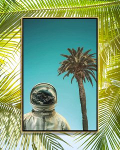 Spaceman standing below a palm tree against a blue sky with Earth reflected in his helmet by iCanvas artist Rob Hakemo