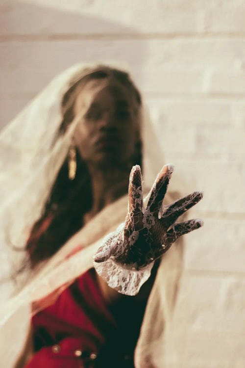 Photograph of a Black woman putting her lace gloved hand toward the camera by iCanvas new creator Giancarlo Laguerta
