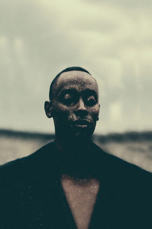Photographed portrait of a black man against a dreary sky by new iCanvas creator Giancarlo LaGuerta
