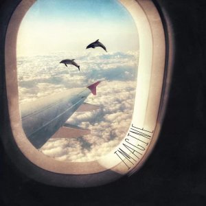 Wall art of the view from a plane window featuring dolphins swimming in a cloudy sky