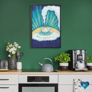 Minimalist kitchen counter with framed wall art of a sun behind a coffee mug that reads "have a jolly day!"