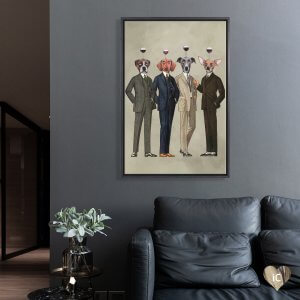 Framed art above green couch of four dogs in suits with glasses of red wine on their heads by iCanvas artist Coco de Paris