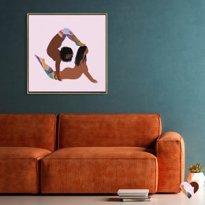 Framed LGBTQ art above orange couch of two black women in rainbow socks doing yoga using each others bodies
