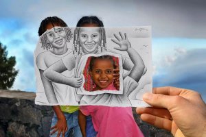 Smile art of three Black children smiling behind a pencil drawn photo of them by iCanvas artist Ben Heine