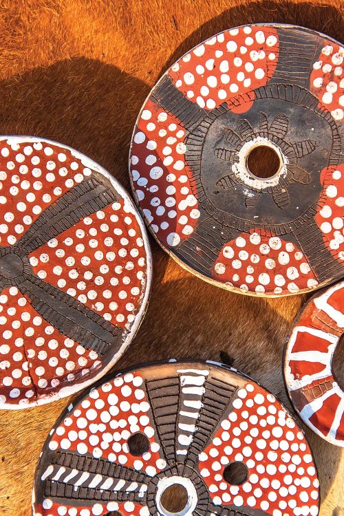 Photography of four red and brown mursi plates with white dots by new iCanvas artist Mark MacLaren Johnson