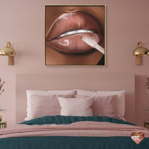 Framed art above bed of close-up of shiny lips applying lip gloss by iCanvas artist DeeLashee Artistry