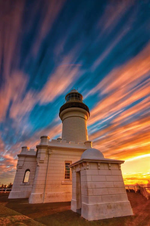 Golden hour photography of a lighthouse below gold and orange sky by new creator Ben Mulder