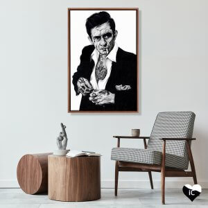 Framed ink art of Johnny Cash with tattoos by Inked Ikons mounted above chair