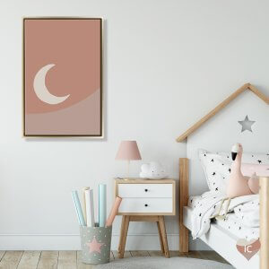 Framed moon art of crescent moon against pink background mounted in child's bedroom by icanvas artist mambo art studio