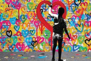 Street art of silhouette of a boy creating colorful heart graffiti art by iCanvas artist DB Waterman