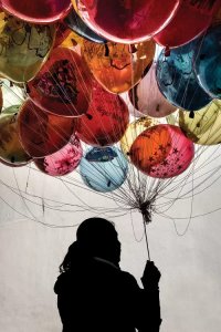 Wall art inspired by Paul Villinskis recycled art of silhouette holding colorful balloons by icanvas artist moises levy