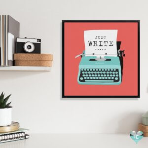 Literary art of a blue typewriter with paper saying “Just Write” on it framed above desk by icanvas artist Peter Walters